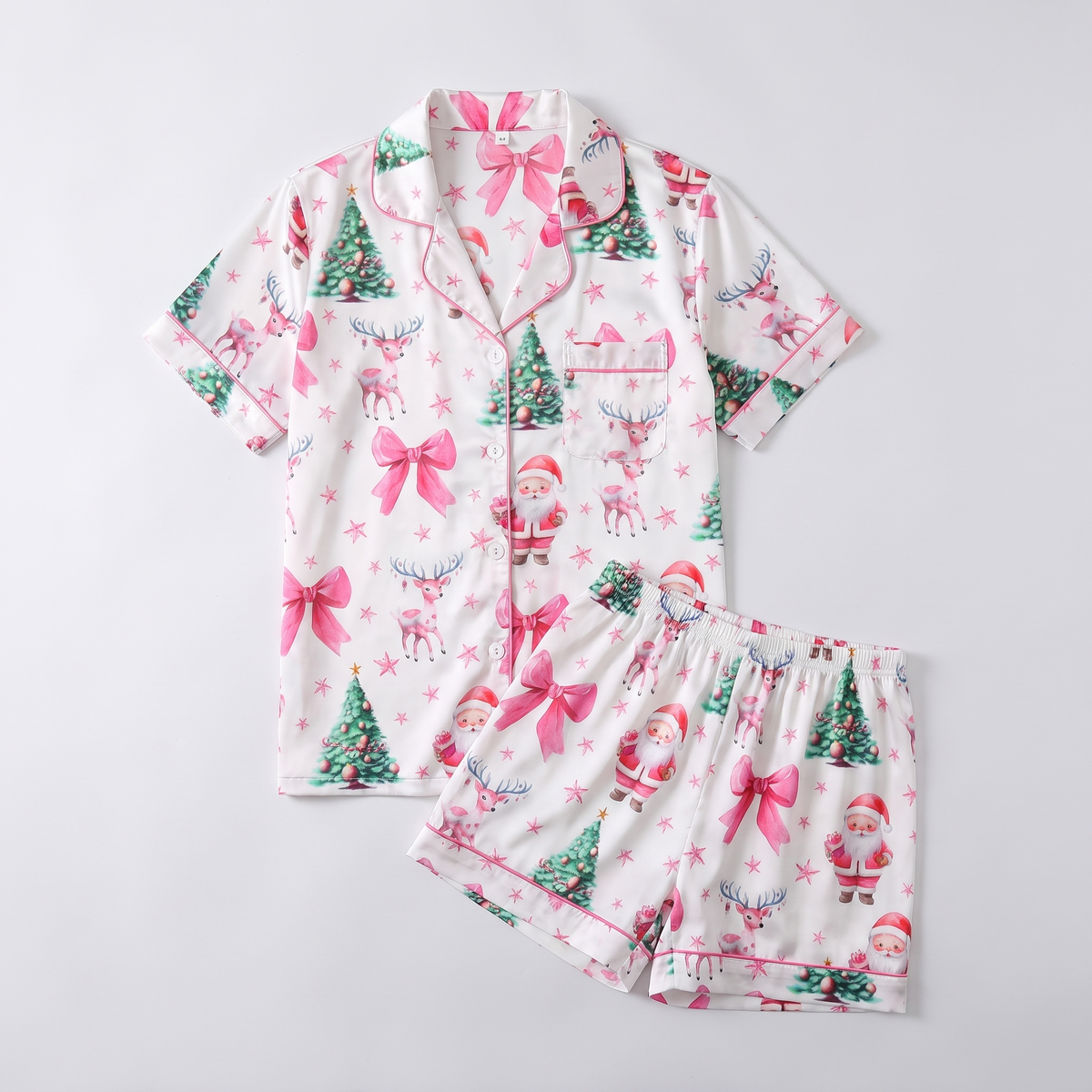 Pink Santas, Bows & Trees Women's Pajama Set - flat lay