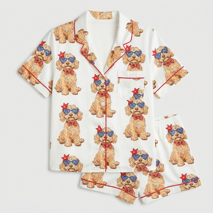 Women's satin pajama set with curly Goldendoodles in star sunglasses and red bow ties on white with red piping - flat lay