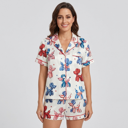 Women's satin pajama set with red, white and blue balloon dogs and confetti stars on white - short sleeve and shorts