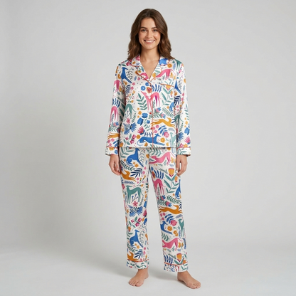 Women's satin pajama set with colorful whippets leaping through a folk-art garden of tulips on white - long sleeve and pants