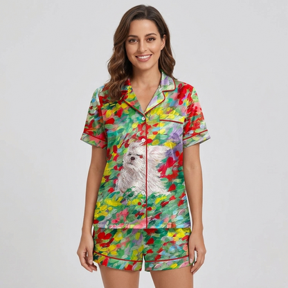 Women's satin pajama set with a fluffy white dog among red, yellow and lilac blooms - short sleeve and shorts