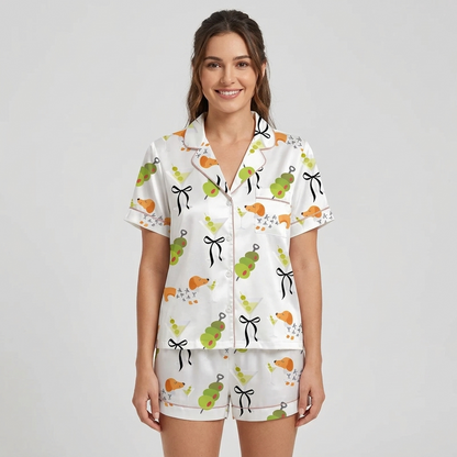Women's satin pajama set with orange dachshunds, martinis, olive skewers and black bows on white - short sleeve and shorts