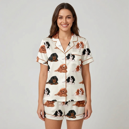 Women's satin pajama set with lounging Cavalier King Charles spaniels on white with red piping - short sleeve and shorts