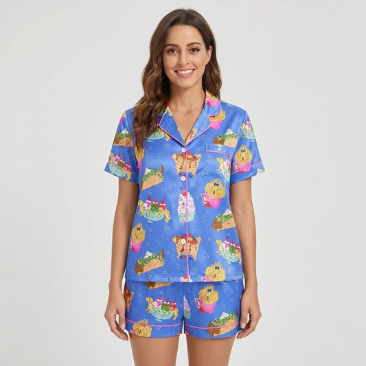 Women's satin pajama set with golden retrievers nestled in burgers, tacos, fries and sundaes on bright blue - short sleeve and shorts