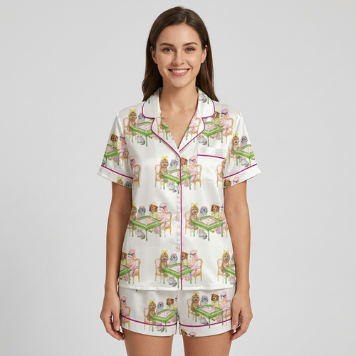 Women's satin pajama set with fluffy dogs in pearls and crowns at green mahjong tables on white with pink piping - short sleeve and shorts