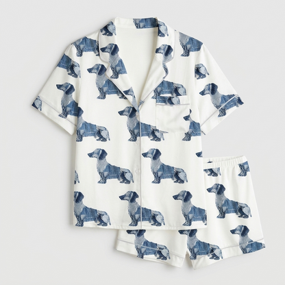 Women's satin pajama set with navy patchwork-style dachshunds in rows on white - flat lay
