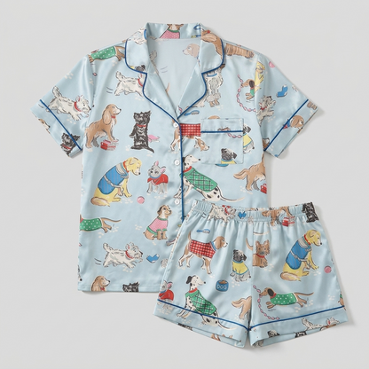 Women's satin pajama set with spaniels, terriers and pugs in plaid knit sweaters on sky blue - flat lay