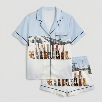 Women's satin pajama set with a row of dogs beside their skis on a snowy mountain slope with lift cables - flat lay