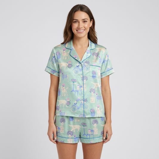 Women's satin pajama set with cream dogs in sunglasses with bicycles and cafe tables on mint green - short sleeve and shorts