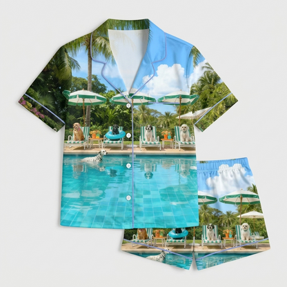 Women's satin pajama set with dogs on loungers under umbrellas by a turquoise pool with palm trees on light blue - flat lay