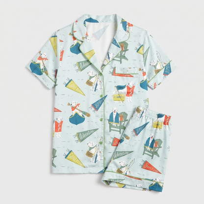 Women's satin pajama set with dogs in Adirondack chairs and canoes with fishing flags on mint green - flat lay