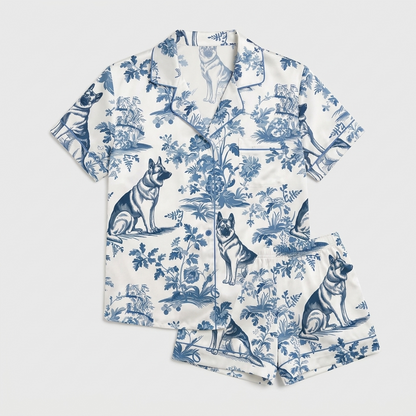 Women's satin pajama set with German Shepherds in a blue-and-white botanical toile scene on white - flat lay