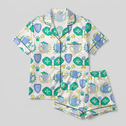 Women's satin pajama set with blue poodles with pickleball paddles and visors on cream - flat lay