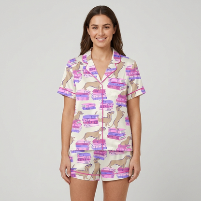 Women's satin pajama set with tan dachshunds sprawled on stacks of pink and purple books on white - short sleeve and shorts