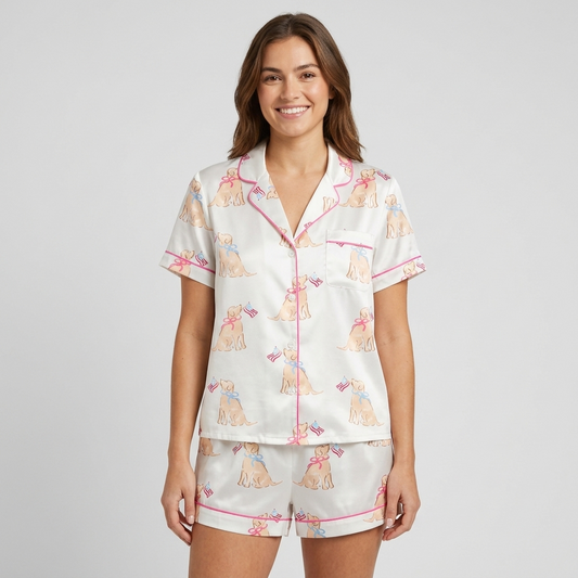 Women's satin pajama set with golden retriever puppies in bows holding tiny flags on soft cream - short sleeve and shorts
