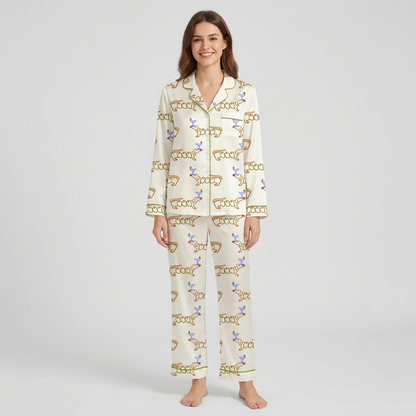 Women's satin pajama set with orange-outlined dachshunds beside lavender martini glasses on white - long sleeve and pants