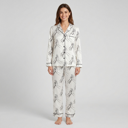 Women's satin pajama set with line-art hand and dog paw high fives on white - long sleeve and pants