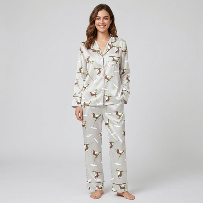 Women's satin pajama set with brown dachshunds leaping around martini glasses and olive picks on pale gray - long sleeve and pants