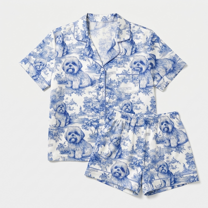 Women's satin pajama set with shih tzus in a blue toile landscape of cottages and hills on white - flat lay