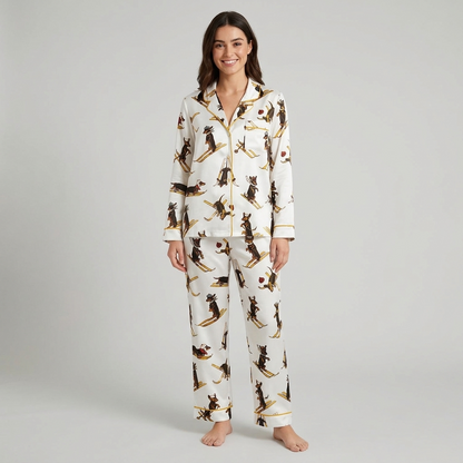 Women's satin pajama set with vintage dachshunds in knit caps skiing on golden skis on white - long sleeve and pants