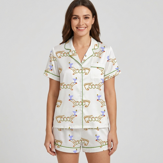 Women's satin pajama set with orange-outlined dachshunds beside lavender martini glasses on white - short sleeve and shorts