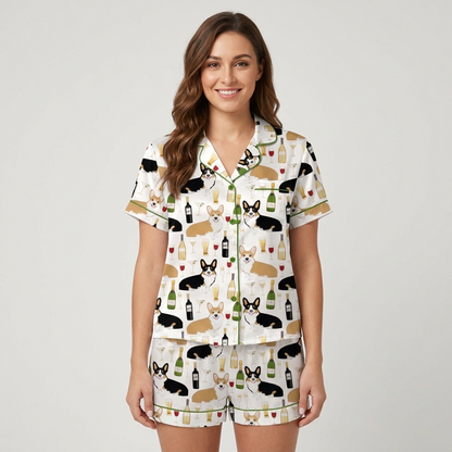 Women's satin pajama set with Pembroke corgis, wine bottles, flutes and goblets on white with green trim - short sleeve and shorts