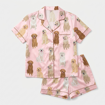 Women's satin pajama set with golden retrievers from cream to deep gold on bubblegum pink - flat lay