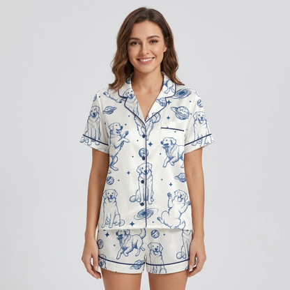 Women's satin pajama set with blue-sketched golden retrievers with ringed planets and stars on white - short sleeve and shorts