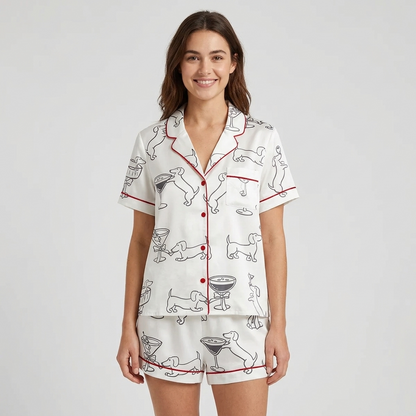 Women's satin pajama set with black-ink dachshunds clinking glasses in martini coupes on white with red trim - short sleeve and shorts