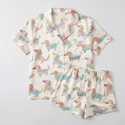 Women's satin pajama set with watercolor dachshunds in knit sweaters in mint, teal and blush on white - flat lay