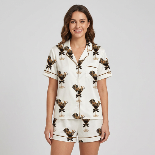 Women's satin pajama set with dachshunds lounging in coupe glasses with black bows on white with brown piping - short sleeve and shorts