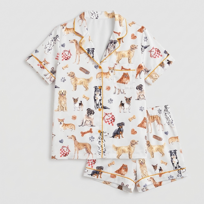 Women's satin pajama set with watercolor golden retrievers, corgis and pugs, bones and paw prints on white - flat lay