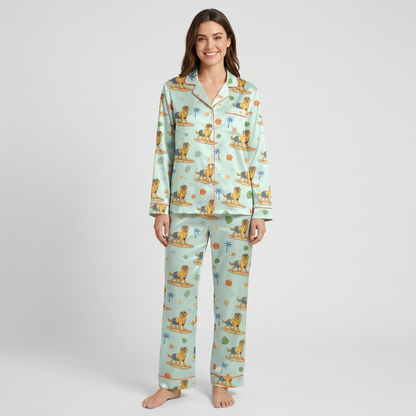 Women's satin pajama set with golden retrievers surfing among palm trees and hibiscus - long sleeve and pants