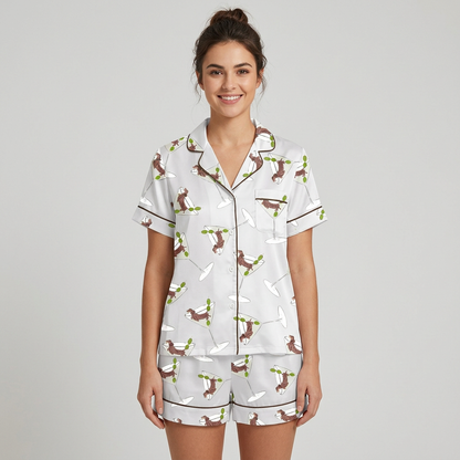 Women's satin pajama set with brown dachshunds leaping around martini glasses and olive picks on pale gray - short sleeve and shorts