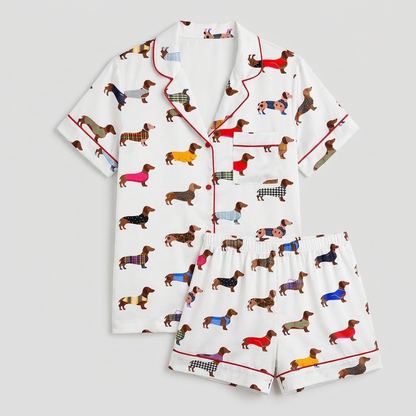 Women's long-sleeve satin pajama set with rows of dachshunds in rainbow tartan and striped sweaters on white - flat lay