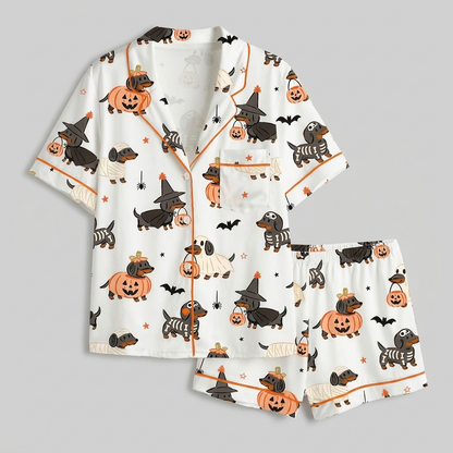 Women's satin pajama set with dachshunds in pumpkins and skeleton, mummy and witch costumes with bats on white - flat lay
