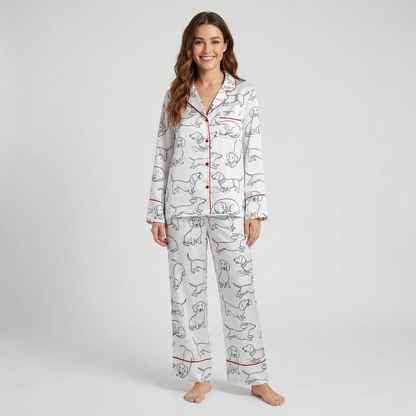 Women's satin pajama set with navy line-drawn dachshunds with red script on white - long sleeve and pants