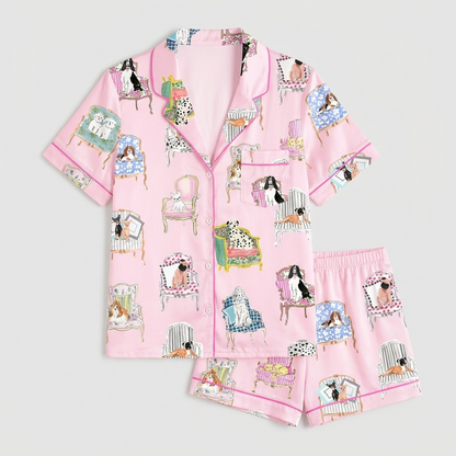 Women's satin pajama set with dogs on watercolor antique armchairs on pale pink with hot pink piping - flat lay