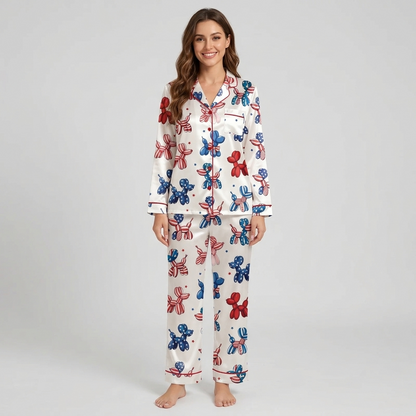 Women's satin pajama set with red, blue and flag-patterned balloon dogs and tiny stars on white - long sleeve and pants