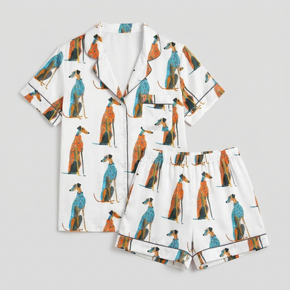 Women's long-sleeve satin pajama set with greyhounds in teal and rust patterned coats in rows on white - flat lay