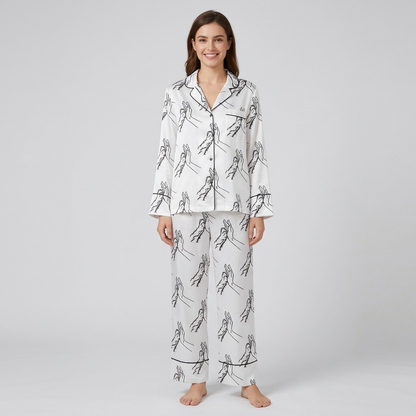 Women's satin pajama set with a black line drawing of a hand high-fiving a dog paw on white - long sleeve and pants