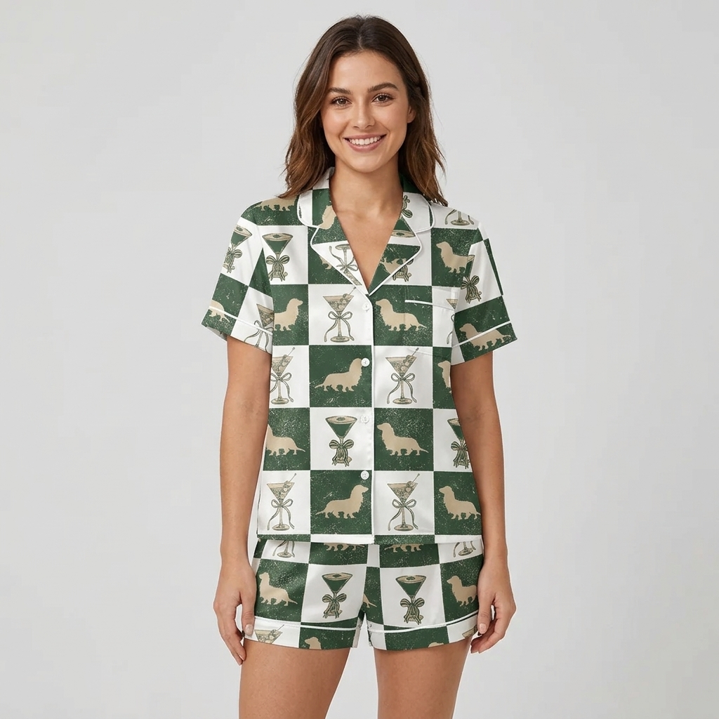 Women's satin pajama set with tan dachshunds and ribbon-wrapped cocktail glasses on a forest green and white checkerboard - short sleeve and shorts