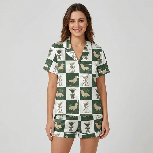 Women's satin pajama set with tan dachshunds and ribbon-wrapped cocktail glasses on a forest green and white checkerboard - short sleeve and shorts