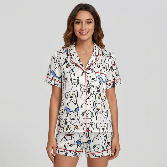 Women's satin pajama set with black line-drawn dogs and dalmatians with blue and mustard ears on white - short sleeve and shorts
