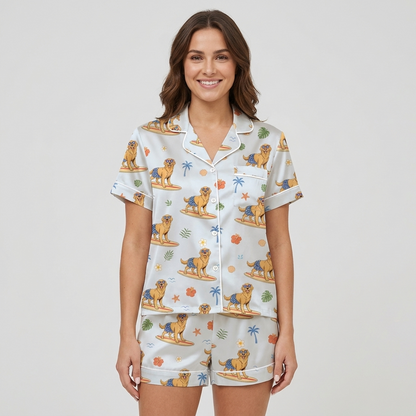 Women's satin pajama set with golden retrievers surfing among palm trees and hibiscus - short sleeve and shorts