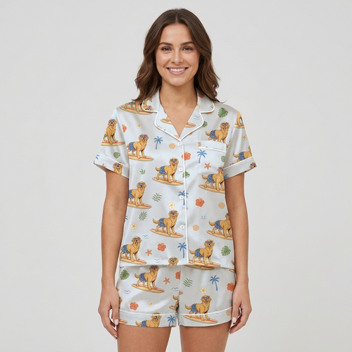 Women's satin pajama set with golden retrievers surfing among palm trees and hibiscus - short sleeve and shorts