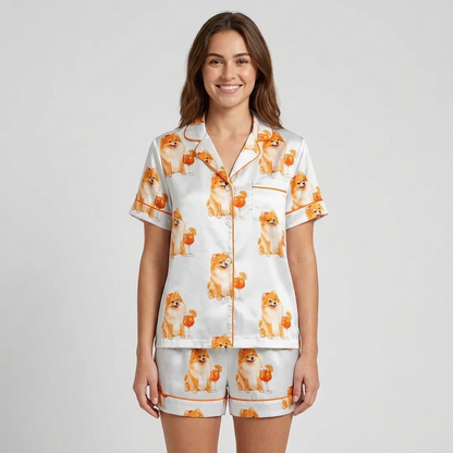 Women's satin pajama set with Pomeranians beside orange spritz cocktails on white with orange piping - short sleeve and shorts