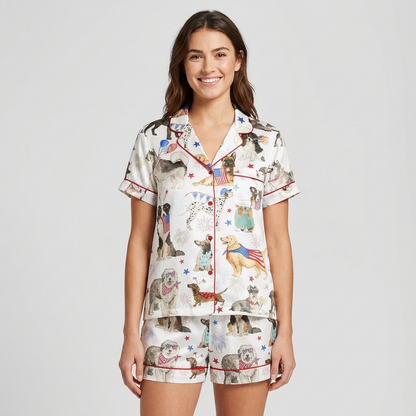 Women's satin pajama set with poodles, retrievers, huskies and dachshunds in Uncle Sam hats with fireworks on white - short sleeve and shorts