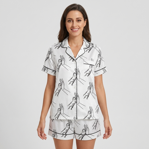 Women's satin pajama set with a black line drawing of a hand high-fiving a dog paw on white - short sleeve and shorts