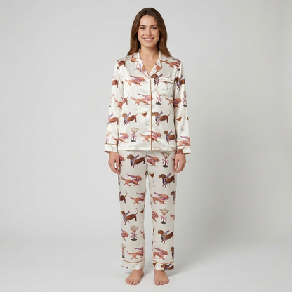 Women's satin pajama set with chestnut dachshunds in floral scarves beside martini glasses on white - long sleeve and pants
